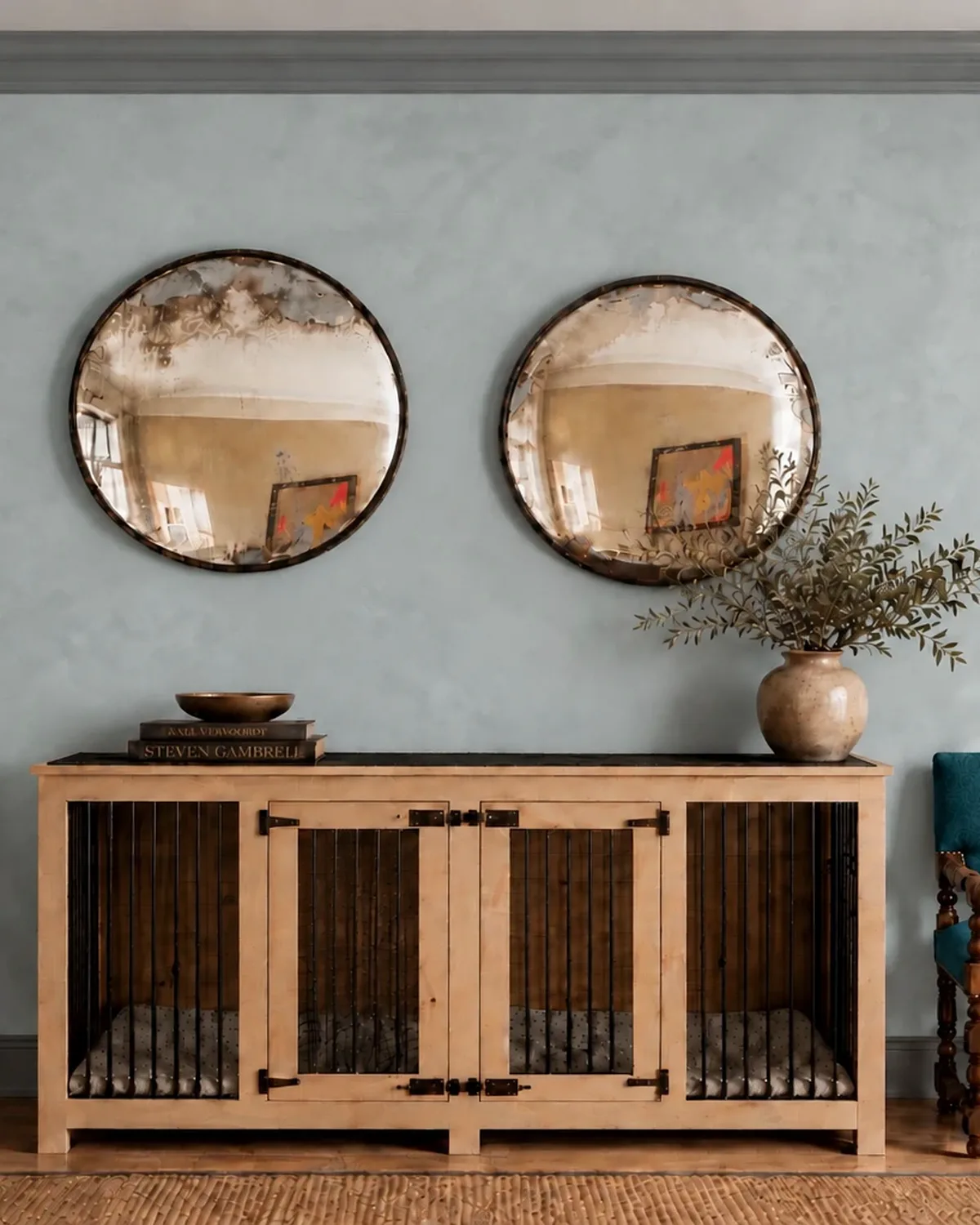 Blue-grey lime plaster walls with grey trim, two round mirrors above a console